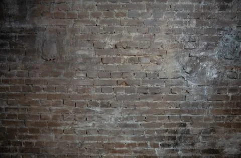 Background in the form of a brown brick wall with light seams 写真素材