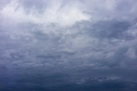 Background in the form of a cloudy gray sky. Stock Photos