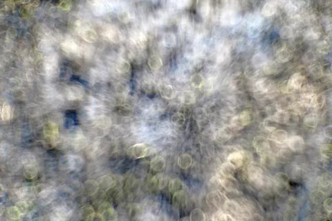 Background in the form of round bokeh restrained white and yellow-green tones Stock Photos