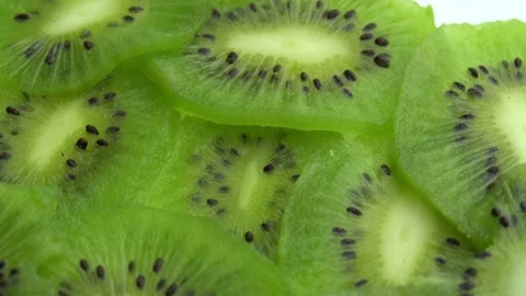 Background in the form of sliced kiwi spins, juicy green kiwi fruit or chinese Stock Footage 164877792