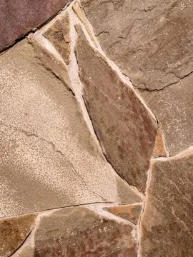 Background in the form of a stone wall made of many flat buta stones of light Stock Photos