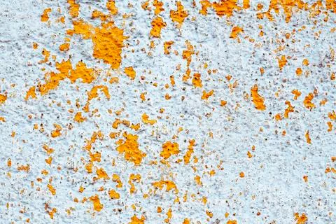 Background in the form of a white wall with peeling yellow paint. Stock Photos