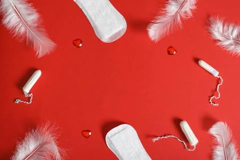 Background frame with pads and tampons on a red background. Stock Photos