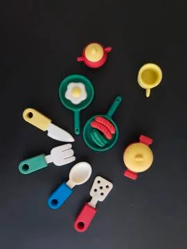 Background of funny and amusing dinner with colored pans and casserole Stock Photos