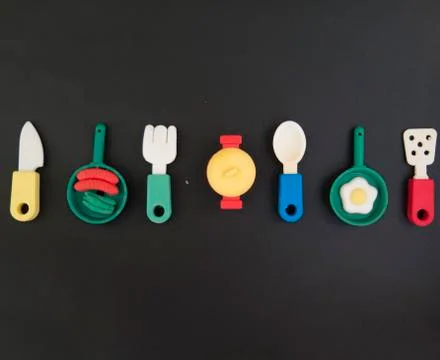 Background of funny and amusing dinner with colored pans and casserole Stock Photos