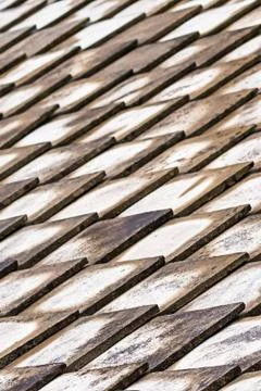 Background geometric gray triangular tiles with dark weathered edges of many Stockfoto's