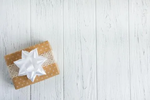 Background with a gift box. Present boxes on a wooden background. Frame for g Stock Photos