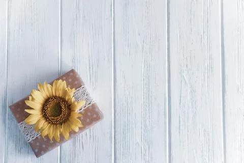 Background with a gift box. Present boxes on a wooden background. Frame for g Stock Photos