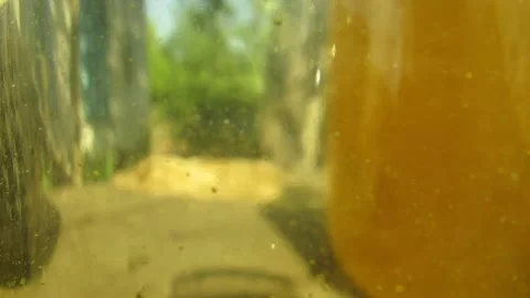 The background on the glass flows down transparent honey beautifully Stock Footage 137434985