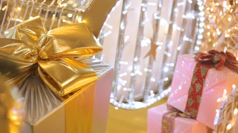 Background: Gold And Pink Boxes With Gifts Among The Glowing Christmas Decorate. Stock Footage 99757201