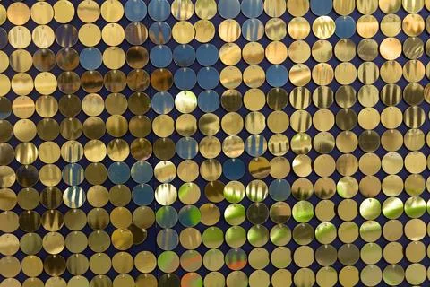 Background from golden sequins in matrix form. Concept of holidays Stock Photos