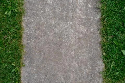 Background from grass and concrete. Stock Photos