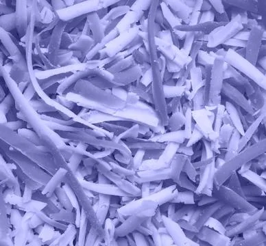 Background of grated cheese colored in new trendy color of 2022 year Very Peri Stock Photos