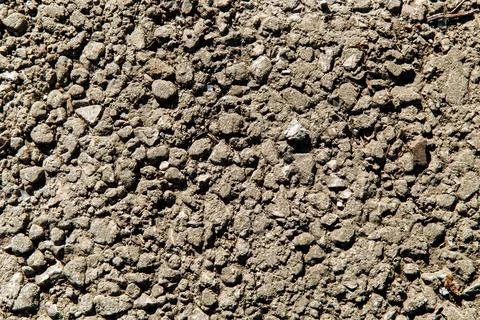 Background of gray crushed stone different forms in the mud Foto stock
