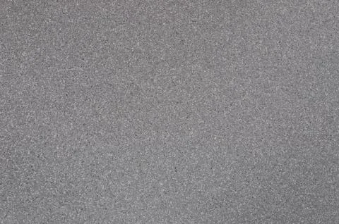 Background of gray granite with spotted texture. Stock Photos