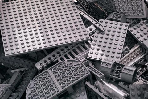 Background of gray Lego blocks, bricks, pieces and baseplates. Stock Photos
