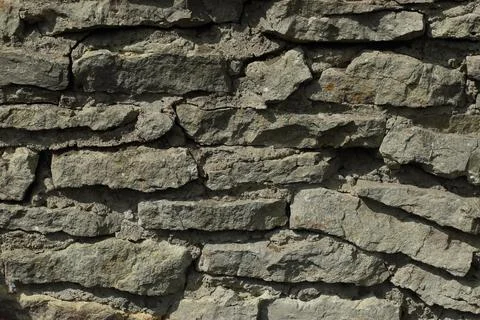 Background of gray stones. A wall of rectangular gray stones 스톡 사진
