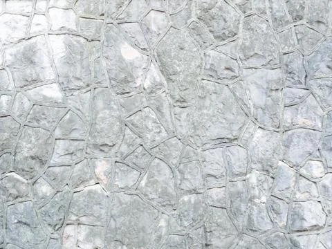 Background gray textured wall with rough patterned masonry. Full screen photo Stock Photos