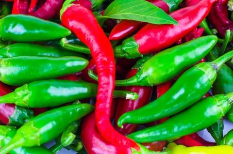 Background from green and red chili peppers Stock Photos