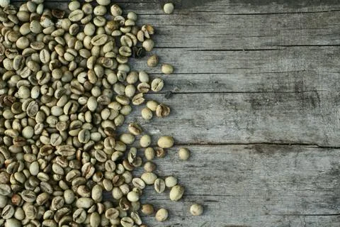 Background of    green coffee beans on rustic wooden Stock Photos