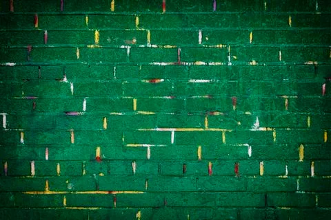 Background of a green painted brick wall with yellow lines Foto stock