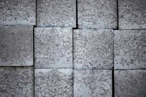 Background with grey construction blocks laying on each other. Stock Photos