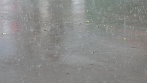Background of heavy rain falling on the street in spring or summer Stock Footage 309584942