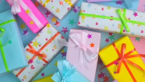 Background with holiday gift boxes in different colors with ribbons and bows or Stock Footage 245604054