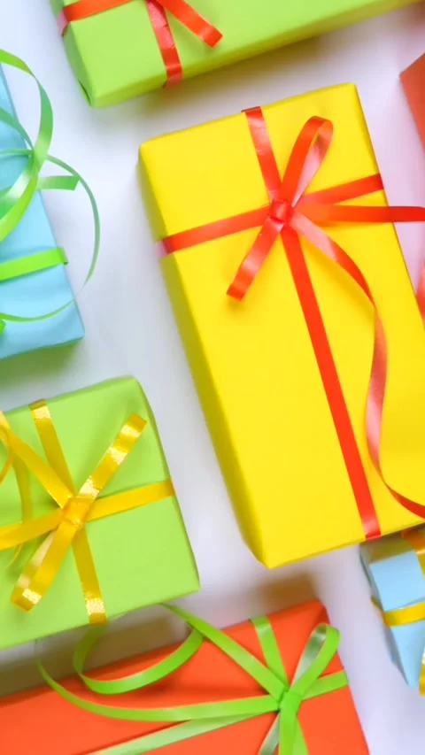 Background with holiday gift boxes in different colors with ribbons and bows or Stock Footage 309692355