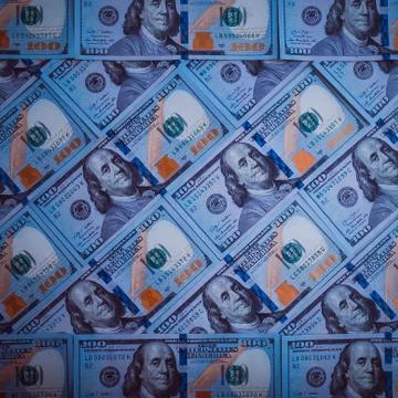 The background of a hundred dollar bills. Blue design. Stock Photos