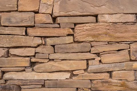 Background image of an ancient stone wall on the ruins of an old home Stock Photos