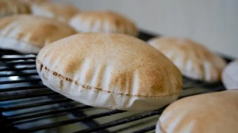 Background image of arabic bread produced in a machine.Arabic bread productio Stock Photos