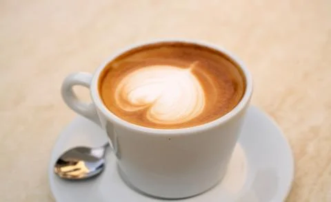 Background image of cappuccino in a cup with coffee beans Stock Photos