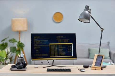 Background image of computer screen with code lines on workplace with devices Stock Photos