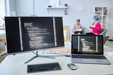 Background image of computer screens with code lines on desk Stockfoto's