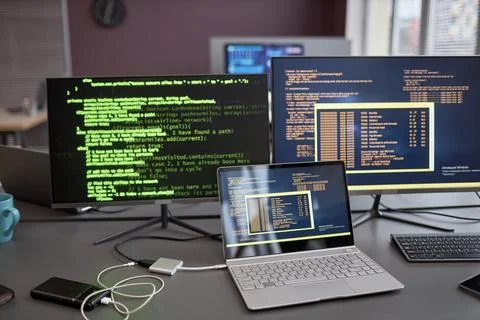 Background image of computers and laptops with green code lines 스톡 사진