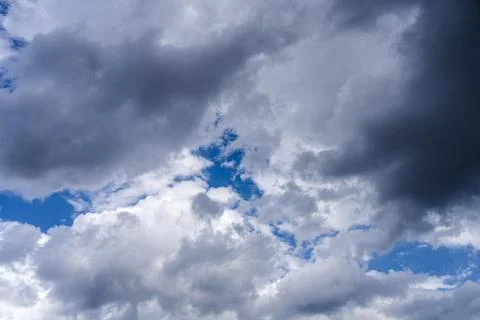 Background image, dark clouds against a blue sky Stock Photos