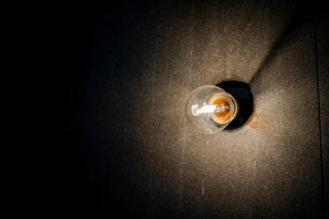 Background image of dark wall with lamp above. Stock Photos