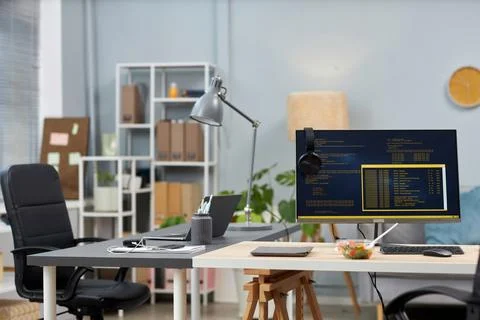 Background image of empty office with two desks and computer code on screens Stock Photos