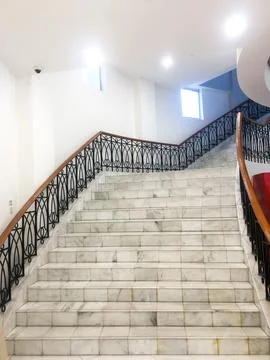 The background of the image features an empty and stylish stairwell, highli.. Stock-Fotos