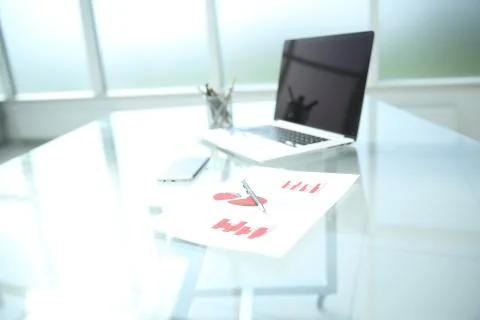 Background image is a financial chart and a pen on the table Stock Photos