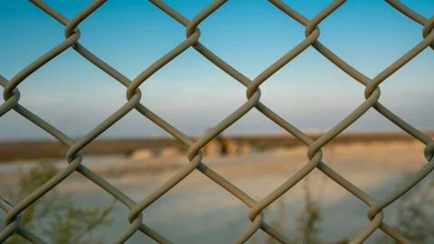Background image of a garden chain link fence Stock Photos