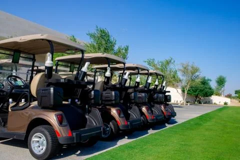 Background image of Golf carts parked on a golf closure in a line. Stock Photos
