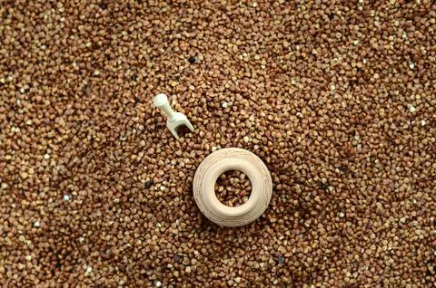 Background image of a large pile of buckwheat, in the middle of which lies a  Stock Photos