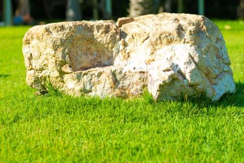 Background image Large stone on green grass, copy space. 스톡 사진