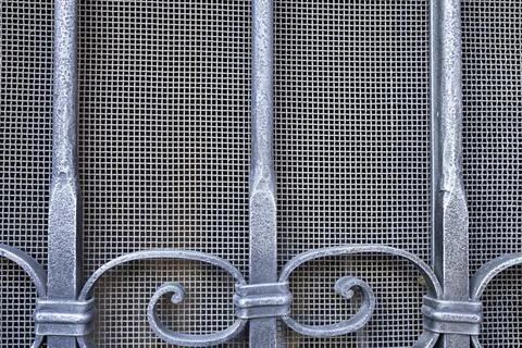 Background image of a metal mesh window Stock Photos