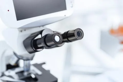 Background image of a microscope on a table in the laboratory. Stock Photos