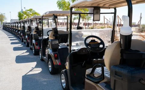 Background image of multiple golf carts parked in order. 写真素材
