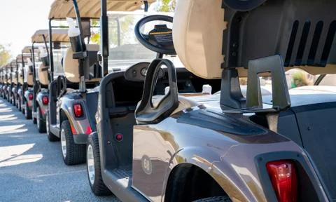 Background image of multiple golf carts parked in order. 스톡 사진