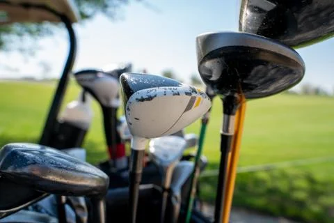 Background image of multiple golf sticks on the behind of a golf cart. 스톡 사진